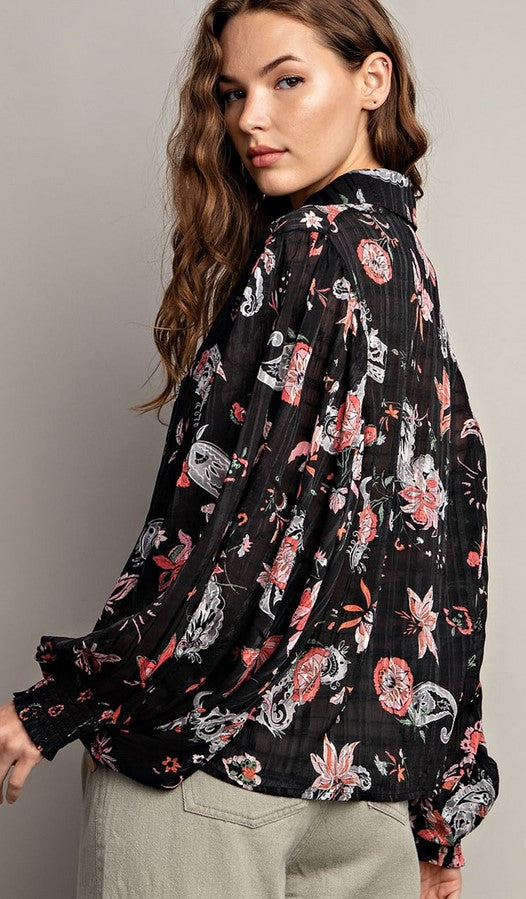 Black sheer blouse with peach and white paisley pattern. Button down front, bishop sleeves, and smocked cuffs.