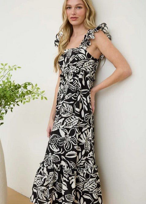 Bold black and white floral dress is lightweight for comfort, and it's lined as well. It has ruffle-style straps. The empire waist has a small ruffle, and the tiered hem has a ruffle as well. Maxi length.