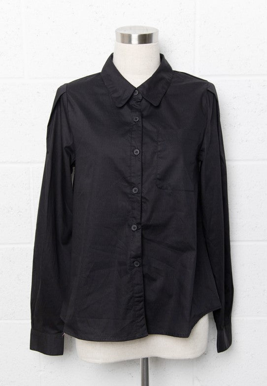 Black collared button-down shirt with puff sleeves. The shirt is on a mannequin, which is placed in front of a white cinder block wall.