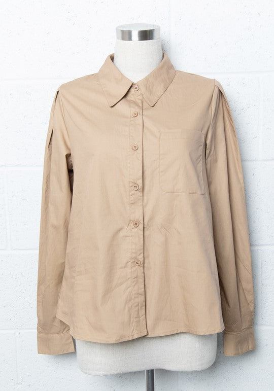 Taupe collared button-down shirt with puff sleeves. The shirt is on a mannequin, which is placed in front of a white cinder block wall.
