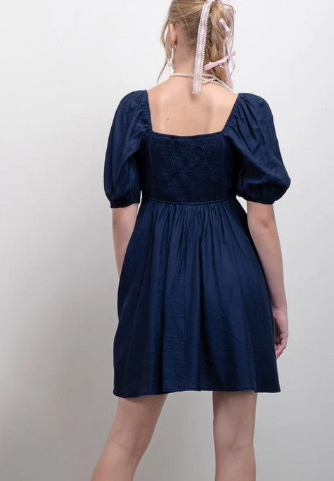 This navy dress will be a staple for your closet. It's fully lined. The softly puffed sleeves are not overpowering, and the pleated bodice adds texture to the look. 