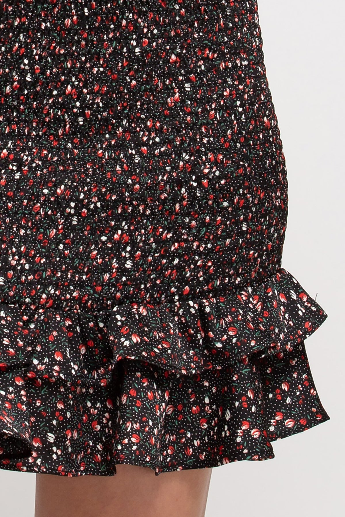 This sweet skirt will be a go-to date-night look! The plum and white ditsy floral pattern on the black skirt is so feminine. The ruffled hem is very flirty, and the smocked skirt hugs in just the right spots.