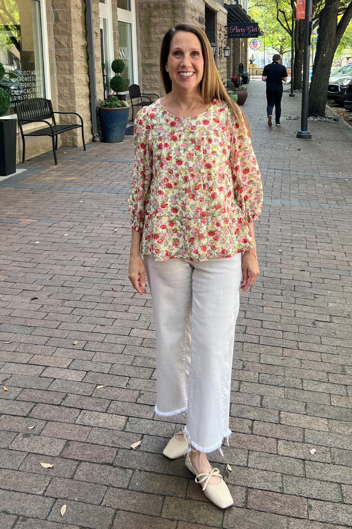 Buttery cream tiered blouse with rose, red and green spring floral pattern. Scoop neck line. Three-quarter length sleeves with elastic cuff. Top is fully lined.