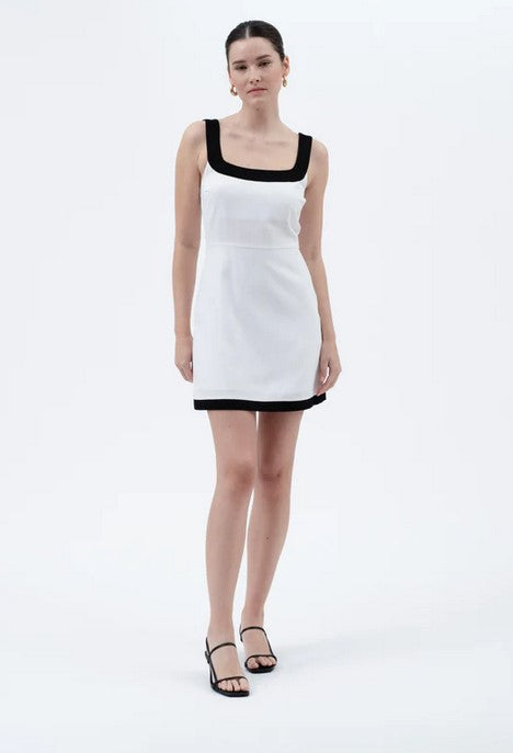 Sexy summer dress has a dramatic contract collar and hem. Dress is lined across the breast,  and the skirt is fully lined as well. Zip up back with adjustable straps.