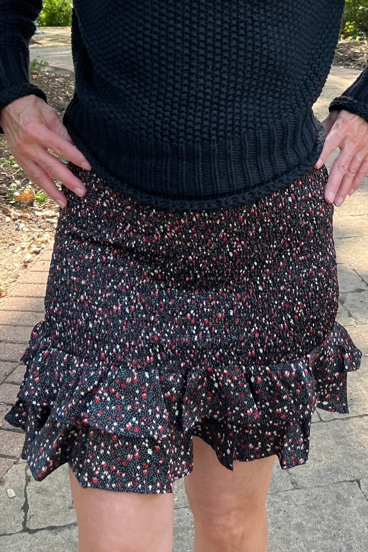 This sweet skirt will be a go-to date-night look! The plum and white ditsy floral pattern on the black skirt is so feminine. The ruffled hem is very flirty, and the smocked skirt hugs in just the right spots. 