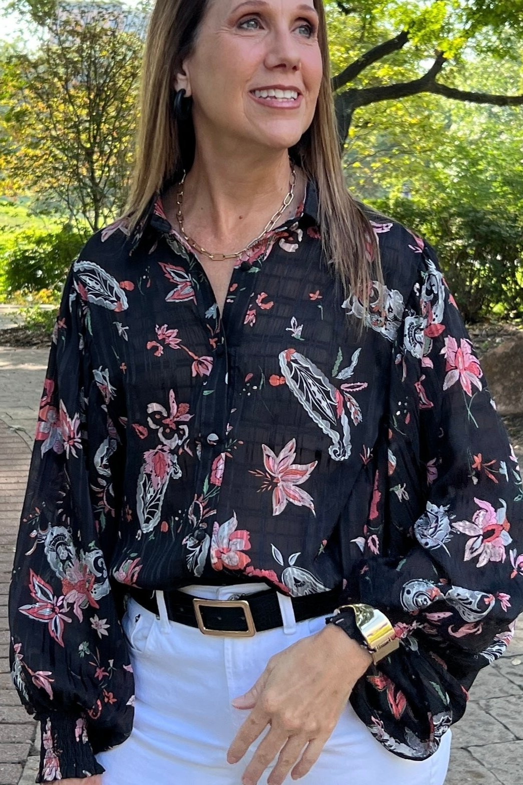 Black sheer blouse with peach and white paisley pattern. Button down front, bishop sleeves, and smocked cuffs. 