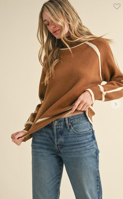 Front view brown turtleneck is a great every day casual sweater. The ivory trim and raglan-style sleeves add a bold flair.