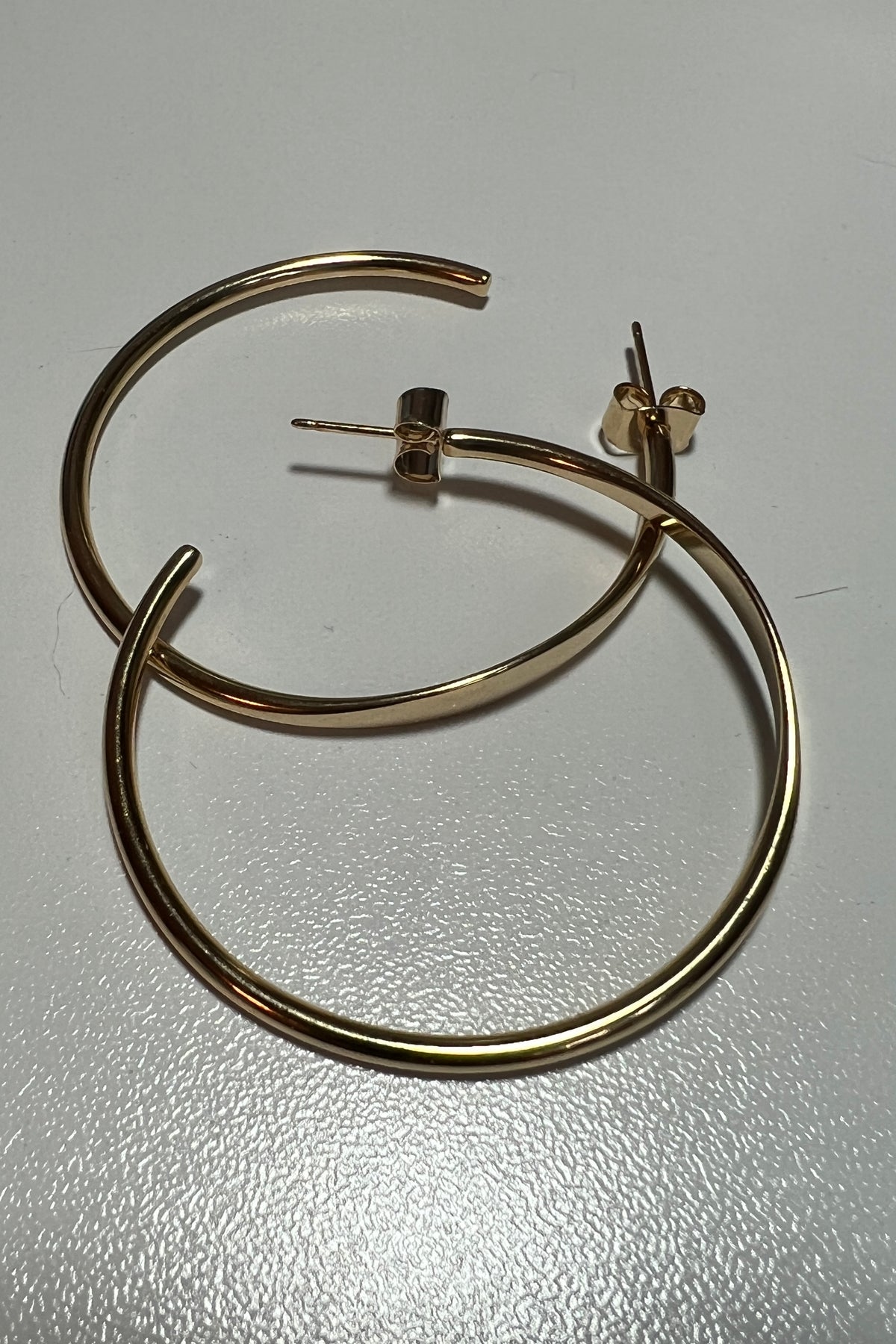 Gold hoop earrings on a white background