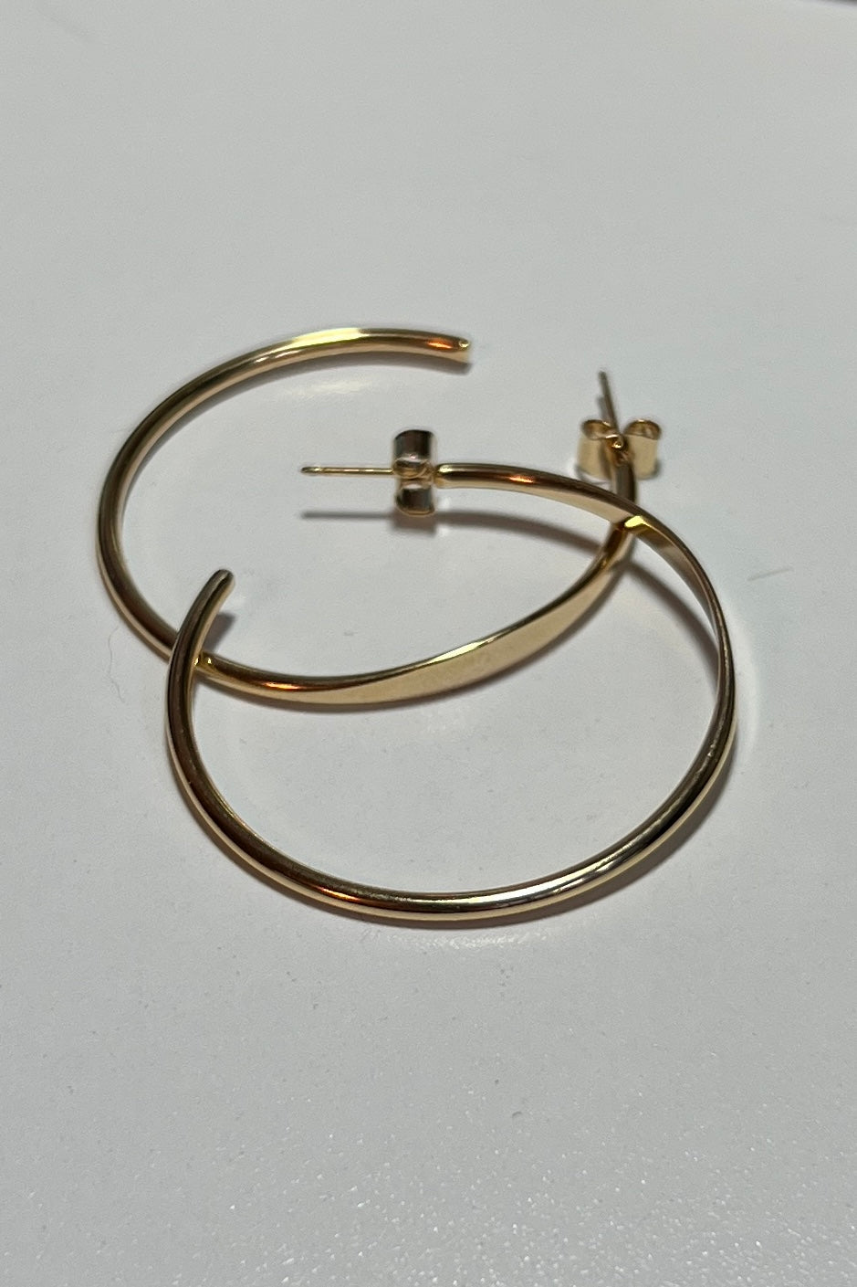 Gold hoop earrings on a white background