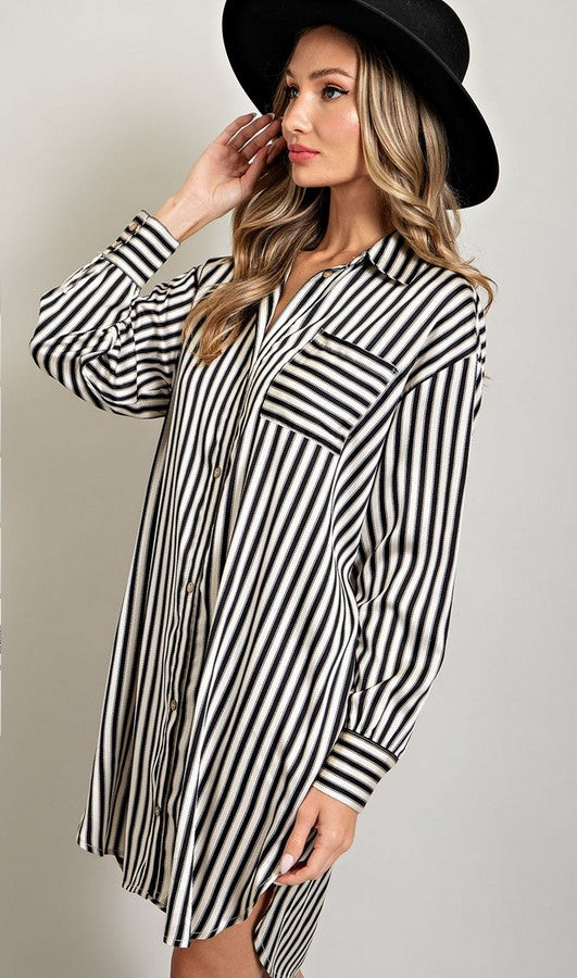 Black and white striped shirt dress made of satin material. Dress has a breast pocket and shirt cuffs. 