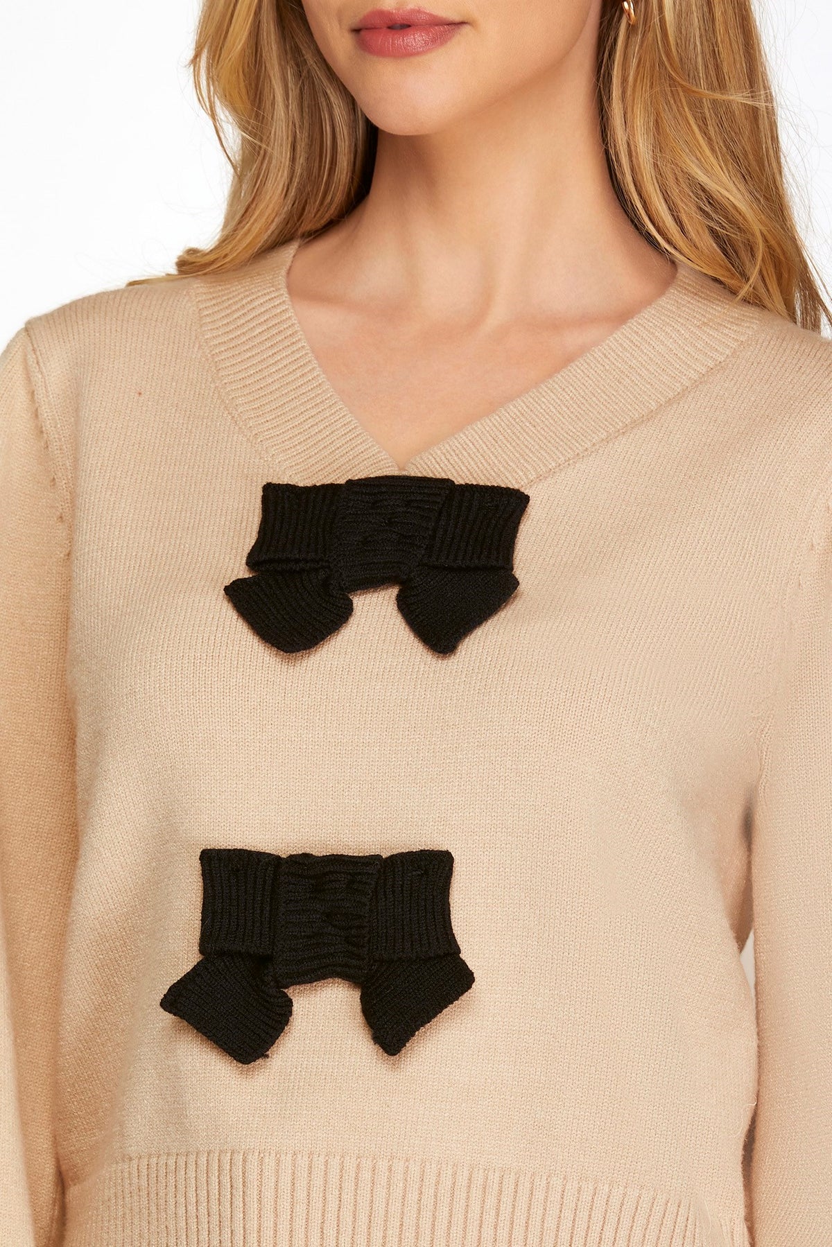 Bring on the bow season! This sweater is so cute on, and it is so soft! The taupe base color is trending, and the black bow details add elegance. The v neck is not too deep, and the cuffed sleeves fit right at the wrist. 