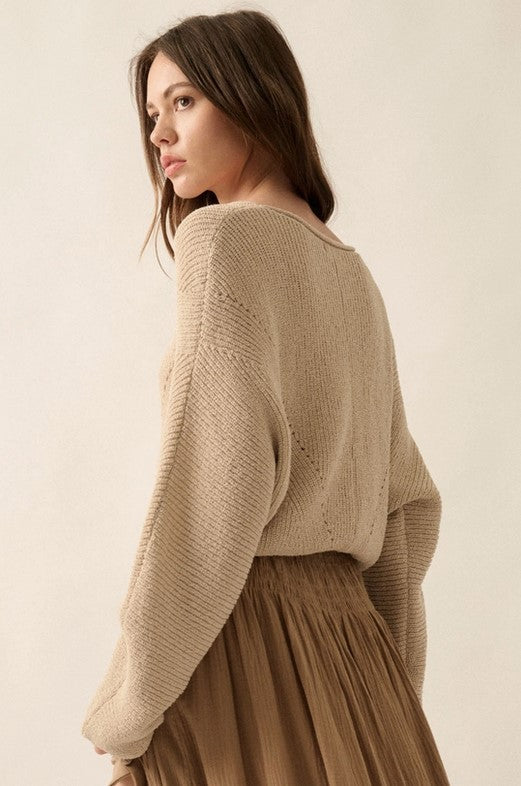 Back view of taupe sweater with extra long sleeves that feel so cozy! It's ribbed with pointelle knit and has a boat neckline and dolman sleeves.