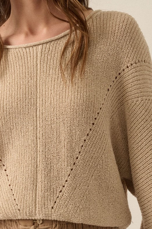 Closeup view of taupe sweater with extra long sleeves that feel so cozy! It's ribbed with pointelle knit and has a boat neckline and dolman sleeves.