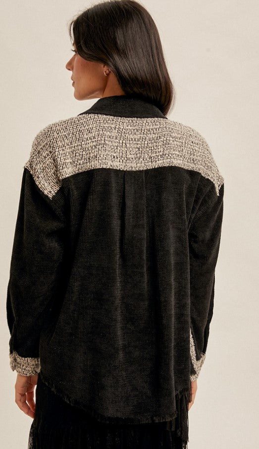 Back view Black Tweed Jacket for your lightweight jacket needs. More for a fashion statement than heavy warmth, this jacket is great for layering over a turtleneck for those warmer Southern winters. The black placket and breast pockets add dimension to the tweed front, and the solid black back blends the look. Unlined.