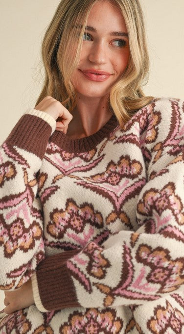 Closeup view of floral sweater brings together all the fall colors--taupe, chocolate, AND mauve! Its round neckline, cuffs, and hem are chocolate brown for a bold pop of color.